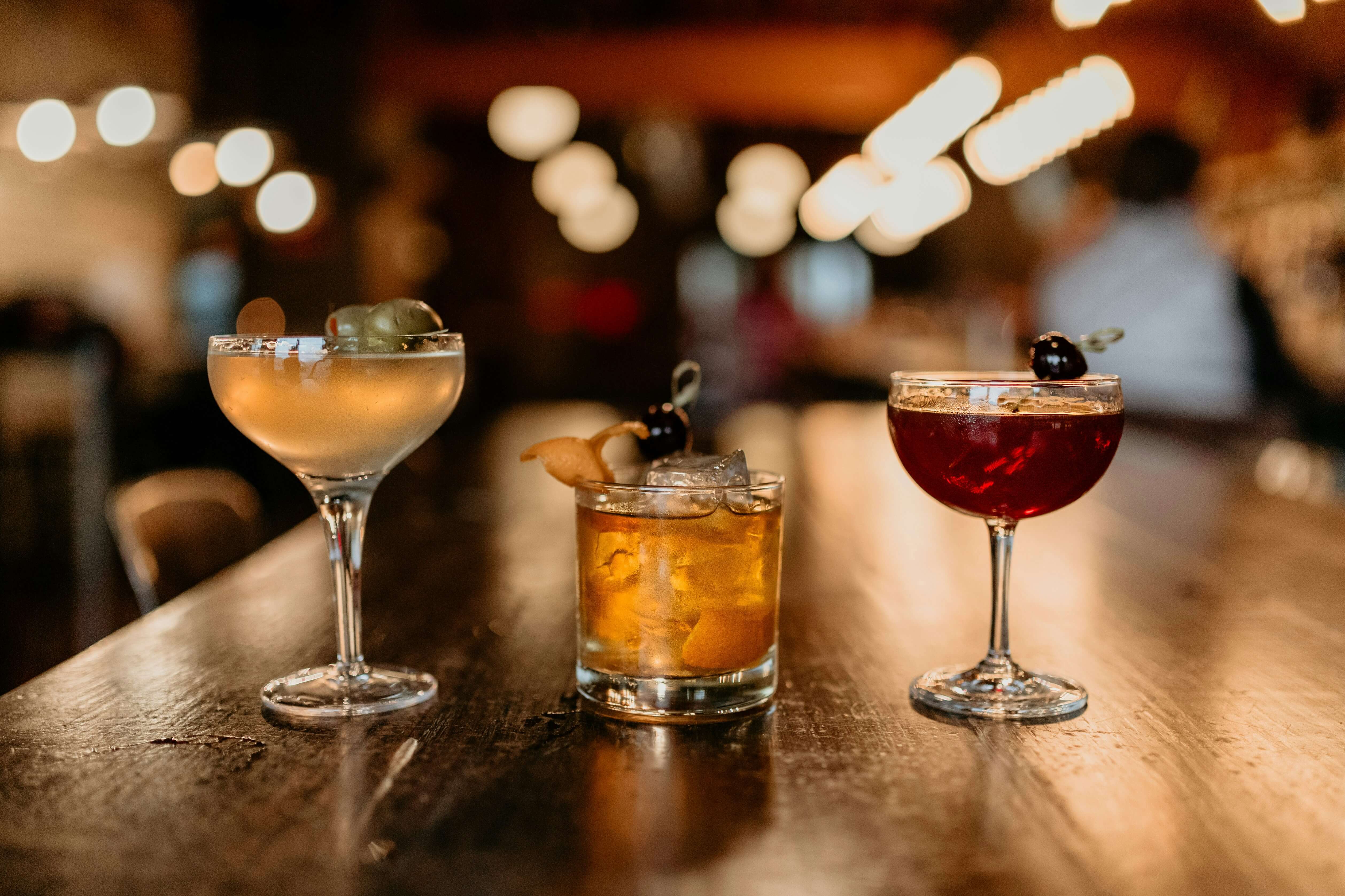 three cocktails on a bar